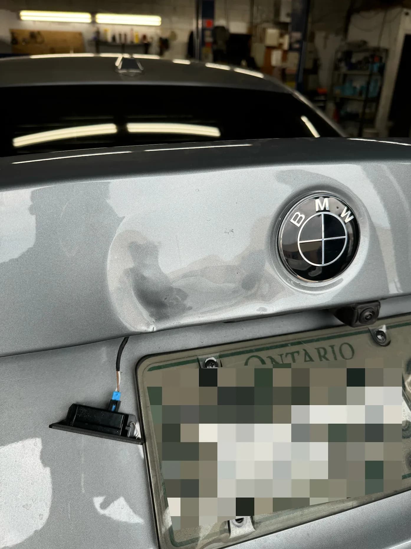 BMW 330i. Trunk lid dent repair before